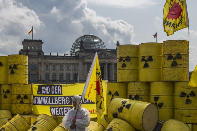 Environmental activists protest with mock nuclear waste barrels outside the Reichstag, the German parliament, in Berlin.