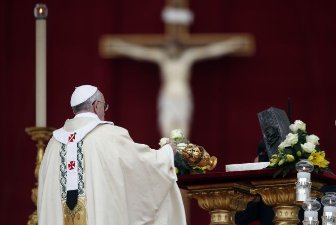 Pope Francis blesses the relics of the Apostle Peter on the altar during a mass at St. Peter's Square at the Vatican 