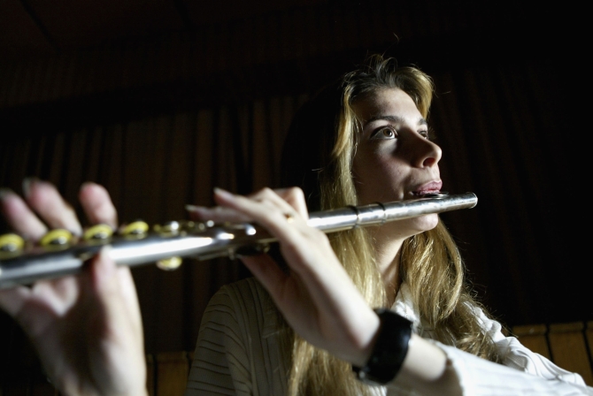 A member of 'Ishtar' plays the flute during a practice session on in Baghdad