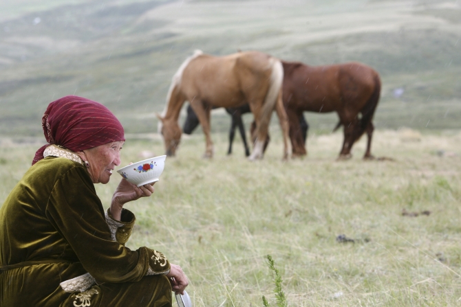 A Kyrgyz woman drinks horse milk at a high altitude summer pasture called Suusamyr, some 170 km south of the Kyrgyz capital Bishkek. Having brought their cattle to the area, local farmers milk their horses to make the local fermented drink kumis, which they sell to supplement their income