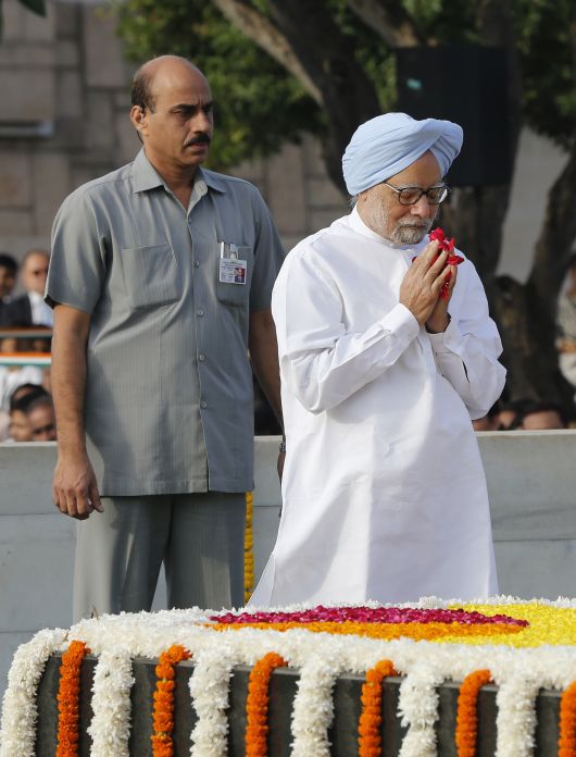 Prime Minister Manmohan Singh pays homage at the Mahatma Gandhi memorial at Rajghat in New Delhi on Wednesday