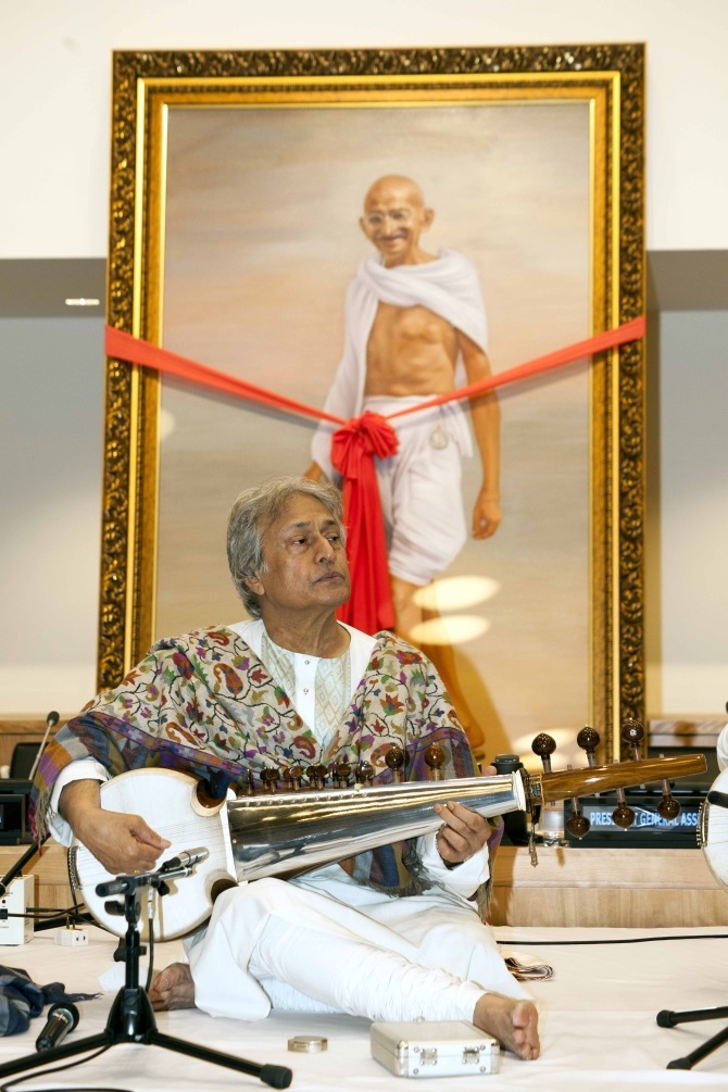 Ustad Amjad Ali Khan performs at the UN on Gandhi's birthday. Seen in the background is a potrait by Mumbai-based artist R D Pareek