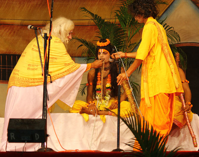 The devoted Shabri tastes each berry to ensure it is sweet before she feeds it to Lord Ram.