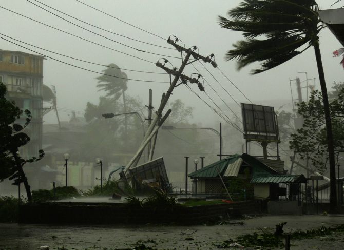 Strong wind and heavy rain blow down electric poles and advertisement signs, and blow away roofs as Cyclone Nargis hits Yangon in this May 3, 2008 photograph. 