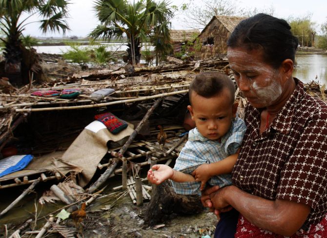 Survivors of Cyclone Nargis walk near a village destroyed by the cyclone in southern Myanmar in May, 2008. 