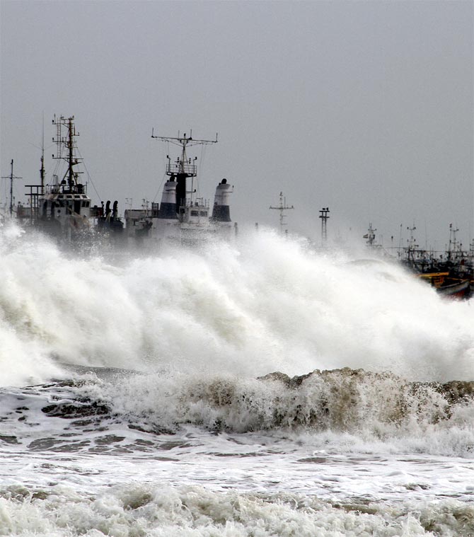 -A big wave smashes into a breakwater at a fishing harbour in Jalaripeta in the Visakhapatnam district in the southern Indian state of Andhra Pradesh
