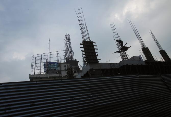 A labourer works at an under-construction shopping mall in Patna