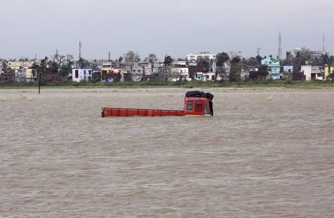 A truck is seen submerged in the water after Cyclone Phailin hit Brahmapur town in Ganjam district