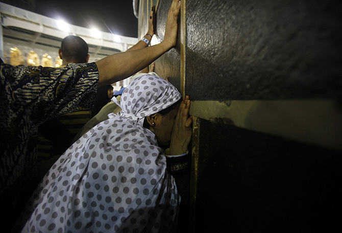 Muslim pilgrims touch the Kaaba at the Grand Mosque in the holy city of Mecca