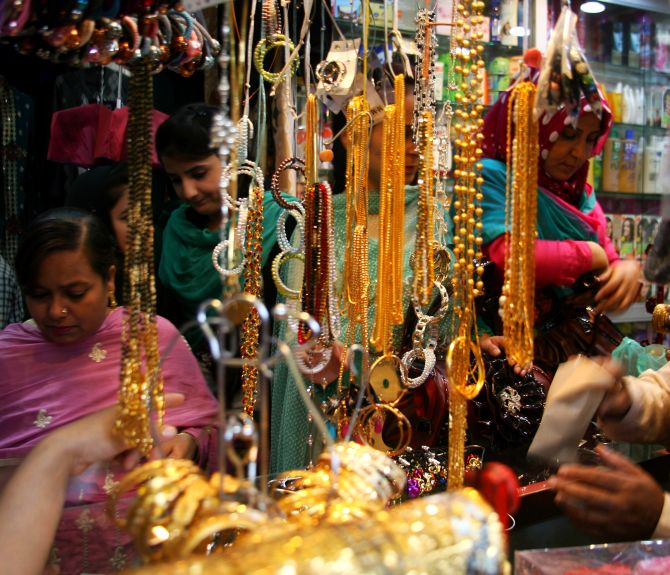 Kashmiri women and girls busy shopping on the eve of Eid-ul-Azha, in a Srinagar market, on Tuesday