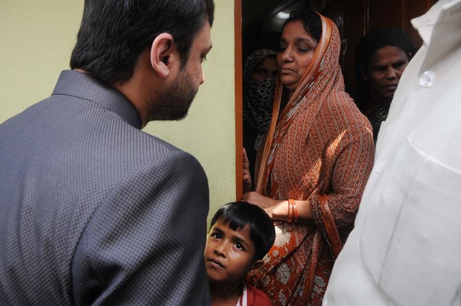 MIM leader Akbaruddin Owaisi consoling Firoz Khan's grieving family in Hyderabad on Thursday
