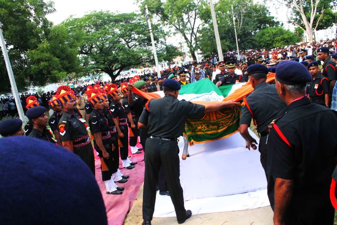 Army personnel draping slain Lance Naik's body with the tricolour ahead of the 21 gun salute
