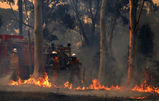 Firefighters work at the scene of a bushfire in Casltereagh, near Sydney