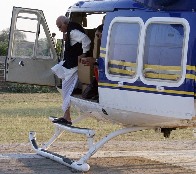 File photo of Bharatiya Janata Party leader L K Advani stepping down from a helicopter during an election campaign rally