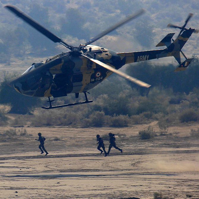An Indian Army's Dhruv transport helicopter takes off after inserting soldiers on the ground during the India-Russian joint military exercise 'INDRA 2013' in the Thar desert, Rajasthan. Photograph: Kind courtesy The Indian Army