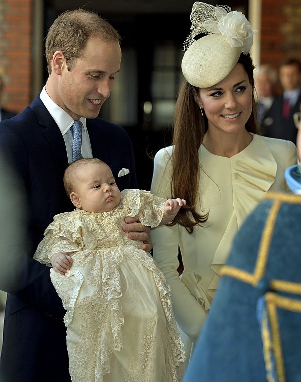 Britain's Prince William carries his son Prince George, as he arrives with his wife Catherine, Duchess of Cambridge for their son's christening at St James's Palace in London