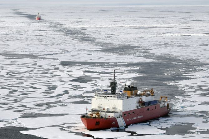 The Coast Guard Cutter Healy breaks ice ahead of the Canadian Coast Guard Ship Louis S. St-Laurent during an Arctic expedition