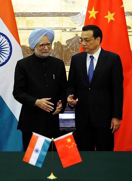Chinese Premier Li Keqiang talks with Prime Minister Manmohan Singh during a signing ceremony at the Great Hall of the People in Beijing, on October 23