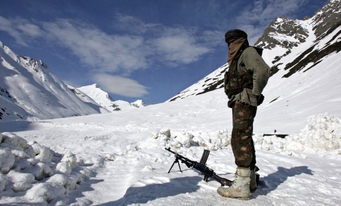 An Indian army soldier guards a mountain pass in Ladakh