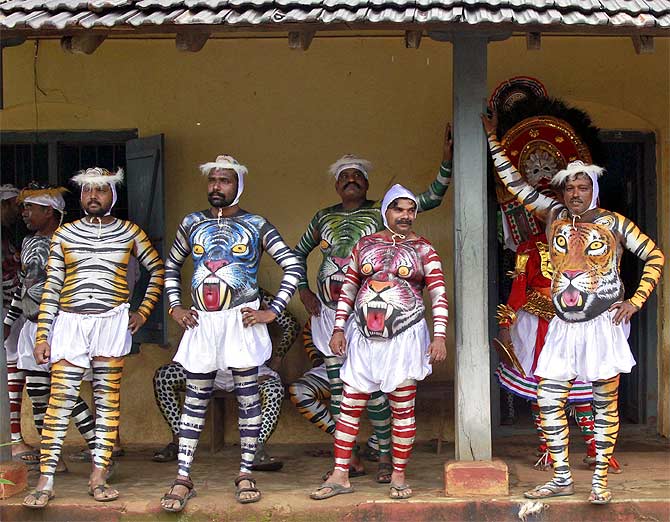 Dancers in body paint during the harvest festival of Onam in Kochi, Kerala.