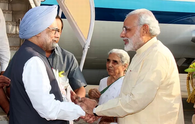 Gujarat Chief Minister Narendra Modi greets Prime Minister Manmohan Singh in Ahmedabad