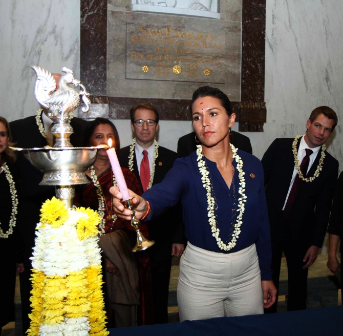 Tulsi Gabbard, Hawaii Democrat and the only Hindu American in the US Congress lights up the ceremonial diya