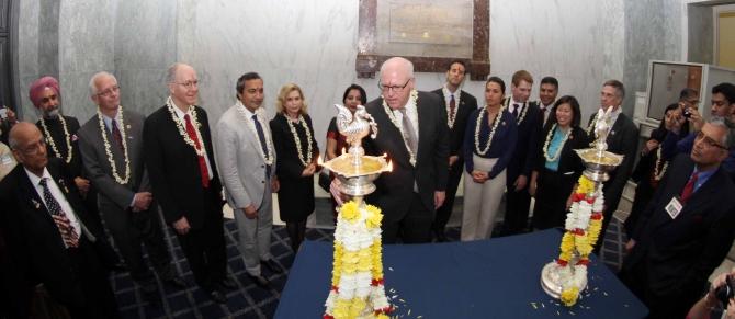 Congressman Joe Crowley lights the diya as US Representative for California Dr Amerish 'Ami' Bera and Tulsi Gabbard look on with others