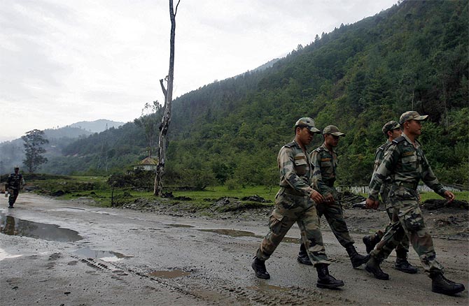 Indian soldiers march near an army base on India's Tezpur-Tawang highway, which runs to the Chinese border, in Arunchal Pradesh