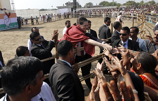 Congress president Sonia Gandhi shakes hands with people during an election campaign in Gujarat