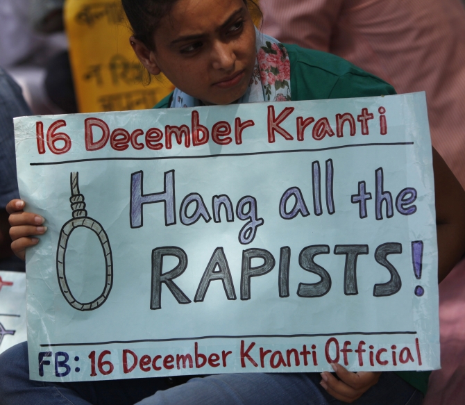 A demonstrator holds a placard during a protest against the verdict of a teenager, who was sentenced to three years in juvenile detention, in New Delhi in the December 16 gang-rape case