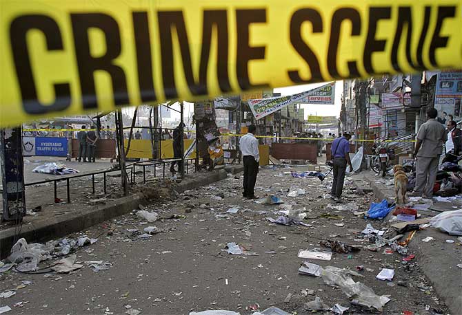 Forensic officials inspect the site of an explosion at Dilsukh Nagar in Hyderabad