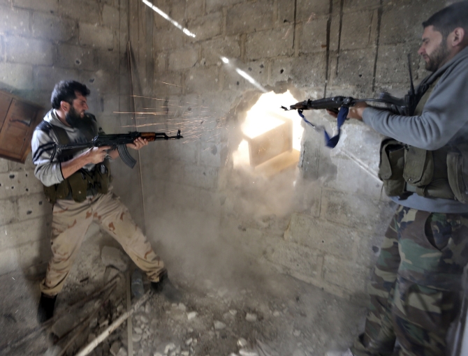 Fighters from the Free Syrian Army's Tahrir al Sham brigade fire at Syrian army positions during heavy fighting in Mleha suburb of Damascus