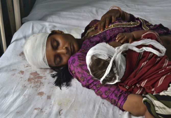 A woman and her child, who were injured in communal clashes, rest on a hospital bed in Muzaffarnagar.