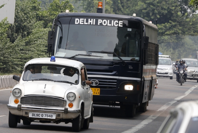 A police bus carrying four men who were found guilty of the fatal gang-rape of a young woman on a bus, arrives at a court in New Delhi