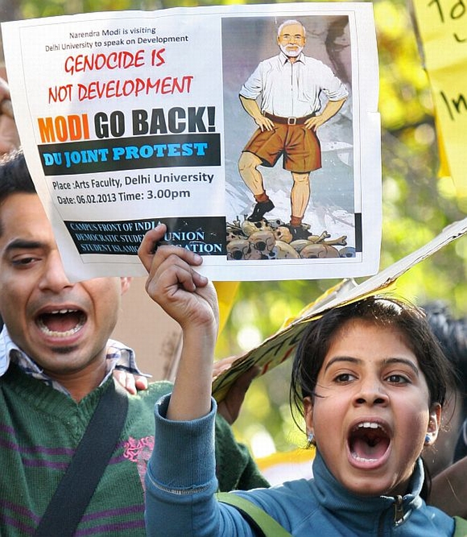 Protestors shout slogans against Modi
