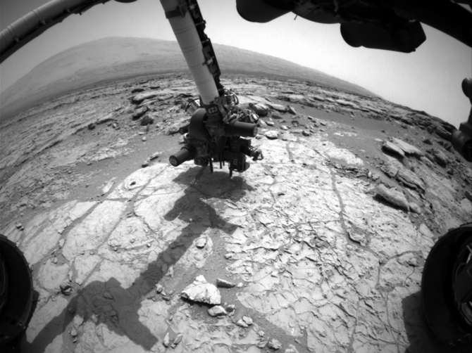 The percussion drill in the turret of tools at the end of the robotic arm of the Mars rover Curiosity is positioned in contact with the rock surface