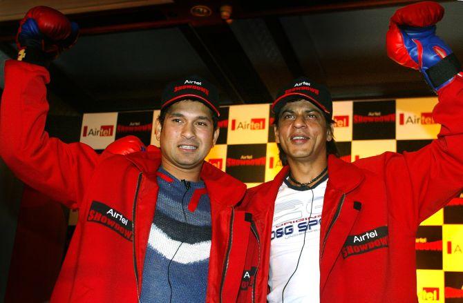 Indian cricketer Sachin Tendulkar and Bollywood star Shah Rukh Khan pose together during a promotional event