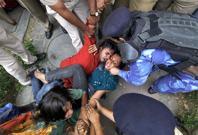 Policemen push protesters during a demonstration against the rising cases of rape in Delhi