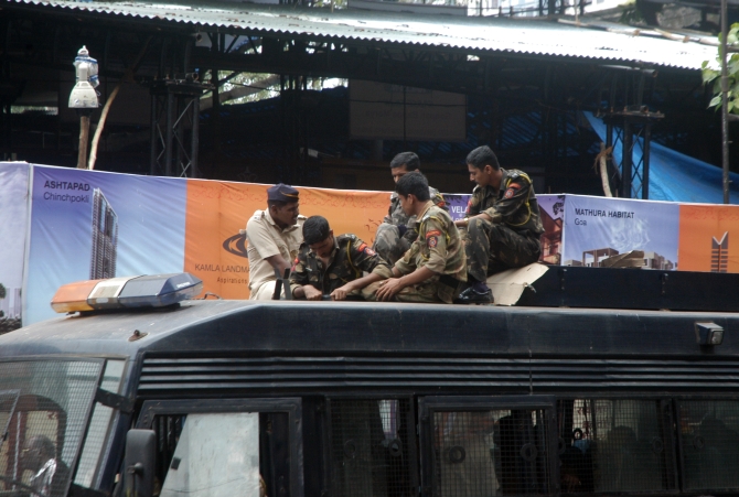 The Mumbai police sit on top of a van on the final day of Ganpati immersion on Wednesday