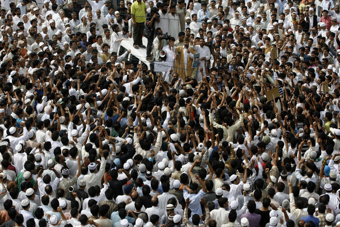 Mirwaiz Umar Farooq (in a light brown robe) addressing protestors