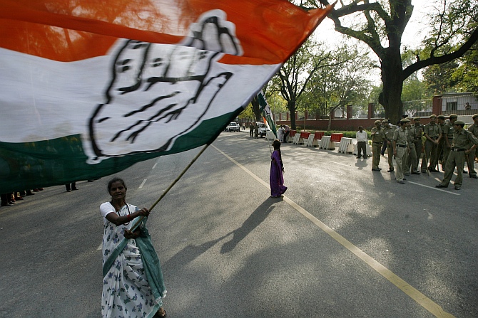 A supporter waves a Congress flag in front of the residence of Congress party chief Sonia Gandhi in New Delhi