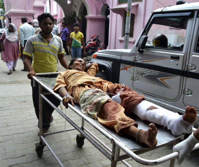 A woman who was injured in communal clashes is rushed to a hospital in Muzaffarnagar 