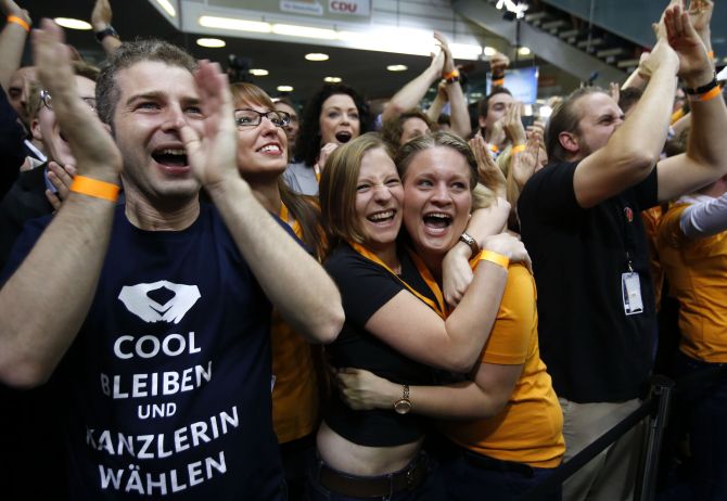 Christian Democratic Union party members celebrate after first exit polls in the German general election