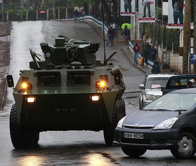 A Kenya Defence Forces (KDF) armoured military vehicle drives to the Westgate shopping centre
