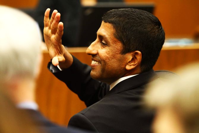 Sri Srinivasan waves to a guest during his swearing-in ceremony