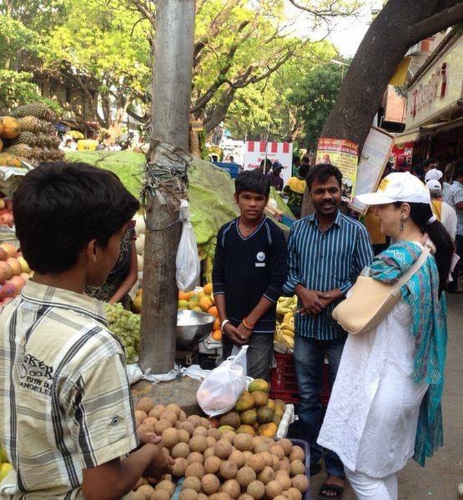 Nandan Nilekani's wife Rohini interacts with vegetable vendors in South Bangalore.