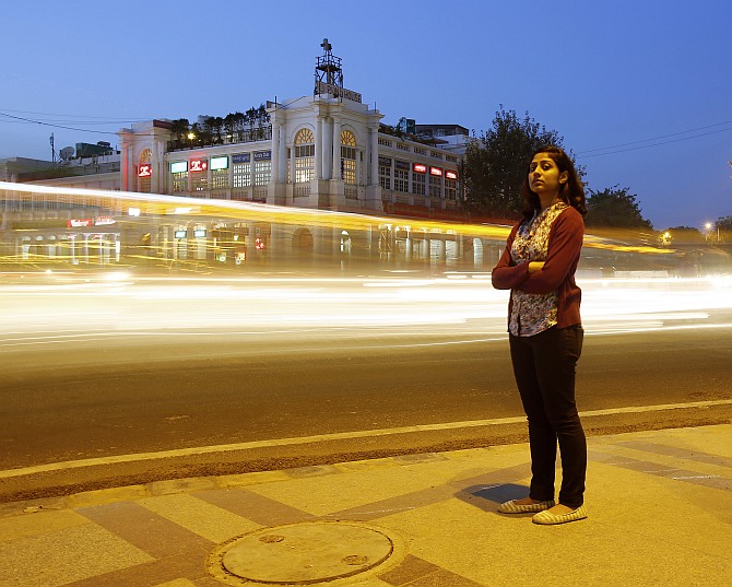 Inayat Naomi Ramdas, 21, poses for a photograph at a busy traffic intersection in New Delhi.