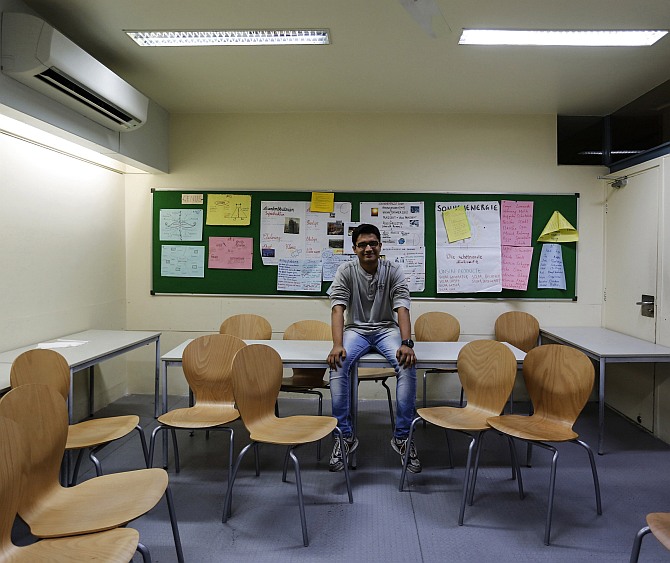 Anuj Trivedi, a 19-year-old student, poses inside his classroom at an institute in Mumbai