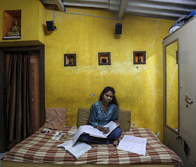 Riteesha Tambe, an 18-year-old college student, poses inside her house in Mumbai.