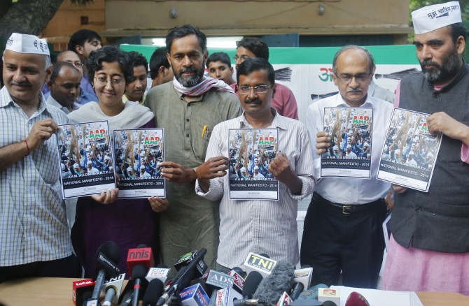 Arvind Kejriwal accompanied by his other party members, hold their party's manifesto ahead of the general election.